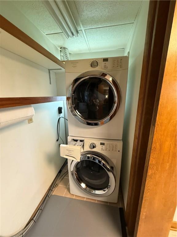 laundry area featuring stacked washer / dryer