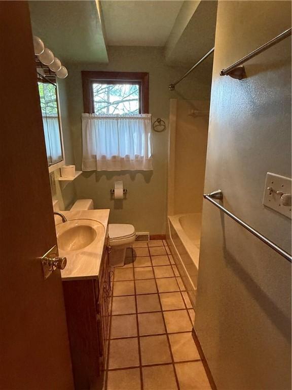 full bathroom with tile patterned floors, toilet, tub / shower combination, and vanity