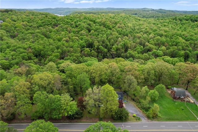 aerial view of property's location featuring a heavily wooded area
