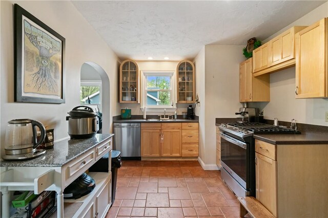 534 Freeport Rd, South Buffalo Twp, PA 16229 - kitchen featuring stainless steel appliances, glass insert cabinets, light brown cabinets, a textured ceiling, and recessed lighting
