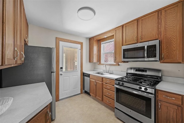 7208 Raymond St, Swissvale, PA 15218 - kitchen featuring stainless steel appliances, a sink, and light countertops