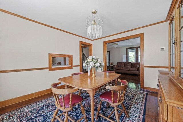7208 Raymond St, Swissvale, PA 15218 - dining room with a chandelier, hardwood / wood-style floors, ornamental molding, and baseboards