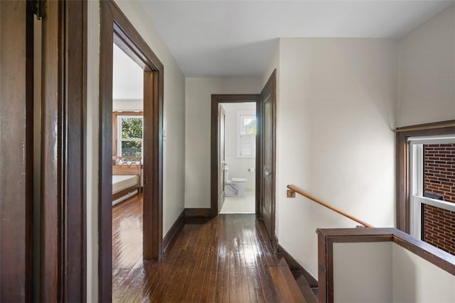 7208 Raymond St, Swissvale, PA 15218 - corridor with an upstairs landing, dark wood-type flooring, and baseboards