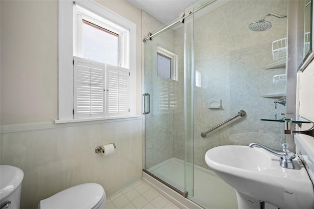 7208 Raymond St, Swissvale, PA 15218 - bathroom featuring toilet, tile patterned floors, a stall shower, and a sink