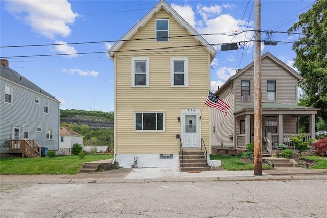 traditional-style house with entry steps and covered porch