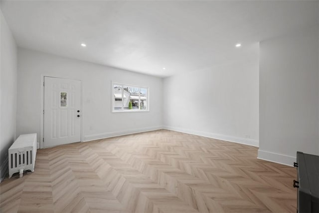 foyer featuring radiator, recessed lighting, and baseboards