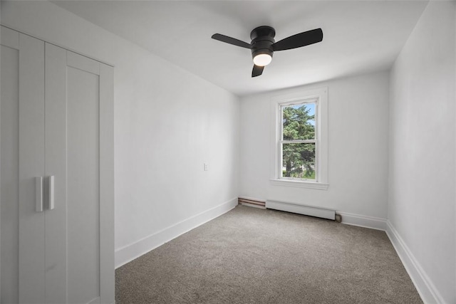 unfurnished bedroom with a baseboard radiator, carpet, baseboards, and ceiling fan