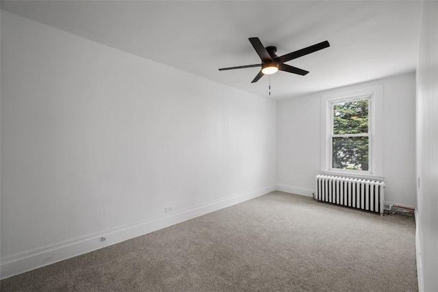 empty room featuring radiator, carpet floors, ceiling fan, and baseboards