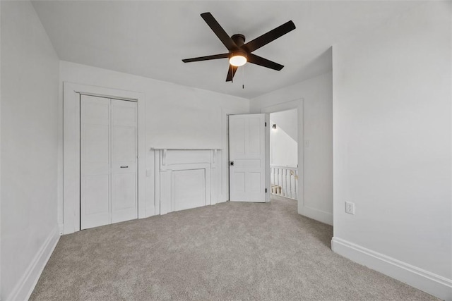 unfurnished bedroom with carpet, baseboards, and a closet