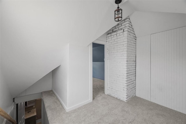 bonus room with lofted ceiling and carpet flooring