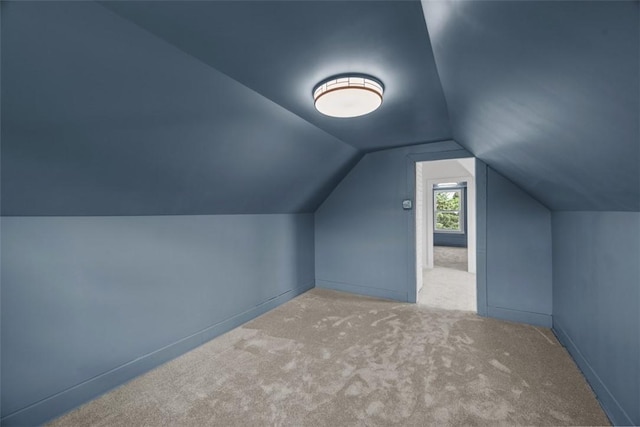 additional living space featuring lofted ceiling and carpet floors