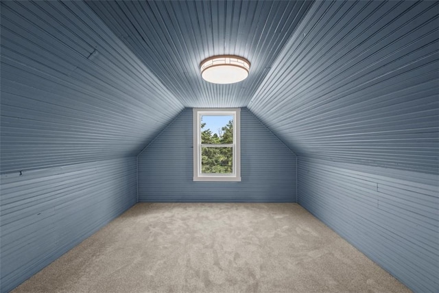 additional living space with carpet floors, lofted ceiling, and wood ceiling
