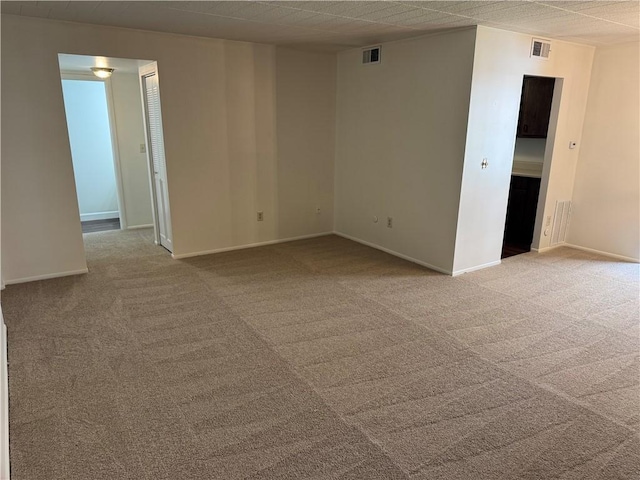 carpeted spare room with baseboards