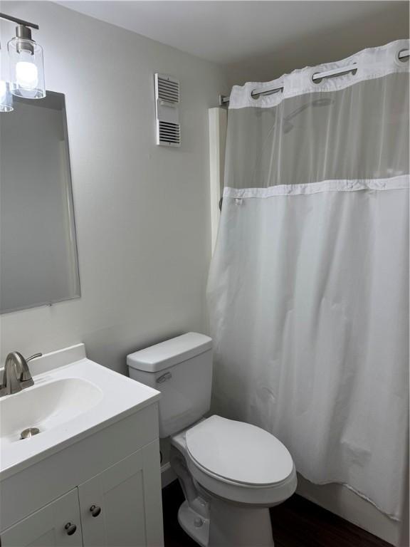 227 S Home Ave Unit 307, Avalon, PA 15202 - full bathroom with toilet, wood finished floors, vanity, and a shower with shower curtain