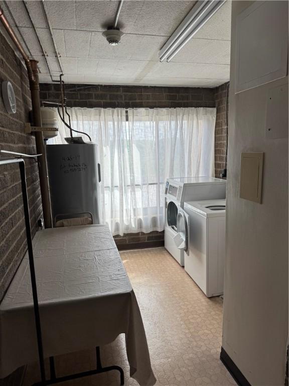 227 S Home Ave Unit 307, Avalon, PA 15202 - clothes washing area featuring separate washer and dryer, light flooring, brick wall, and water heater