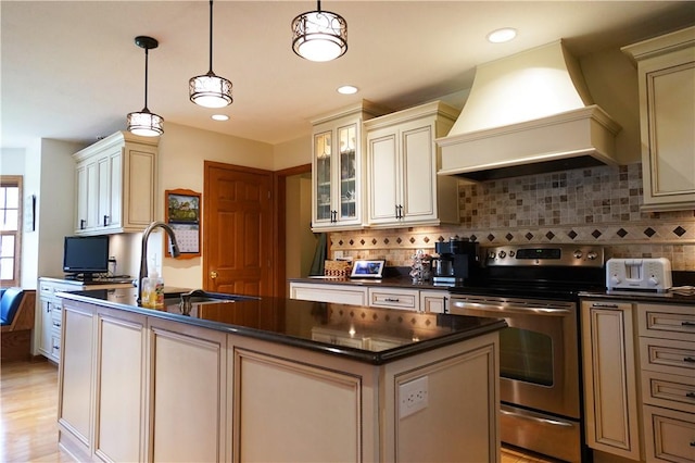 106 Arbor Trl, Slippery Rock Boro, PA 16057 - kitchen with stainless steel range with electric cooktop, custom exhaust hood, cream cabinets, dark countertops, and recessed lighting
