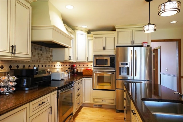 106 Arbor Trl, Slippery Rock Boro, PA 16057 - kitchen with appliances with stainless steel finishes, cream cabinets, custom exhaust hood, a sink, and recessed lighting