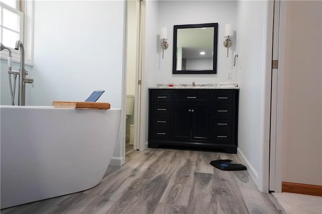 106 Arbor Trl, Slippery Rock Boro, PA 16057 - bathroom with wood finished floors, baseboards, a soaking tub, and vanity