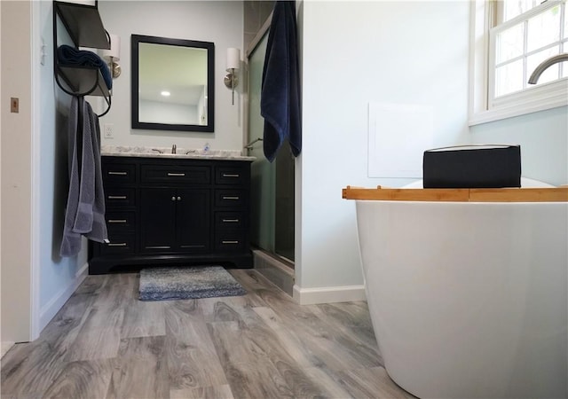 106 Arbor Trl, Slippery Rock Boro, PA 16057 - full bath with baseboards, wood finished floors, vanity, a stall shower, and a freestanding bath