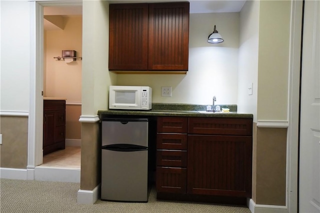 106 Arbor Trl, Slippery Rock Boro, PA 16057 - indoor wet bar featuring white microwave, refrigerator, light colored carpet, and baseboards