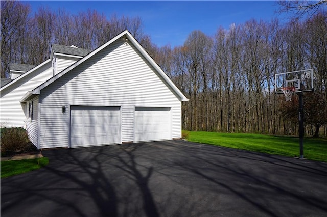 106 Arbor Trl, Slippery Rock Boro, PA 16057 - view of side of home with roof with shingles, driveway, an attached garage, and a lawn