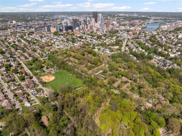 aerial view of property and surrounding area featuring a large body of water