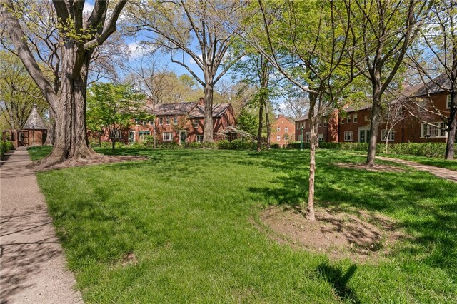 view of green lawn with a residential view