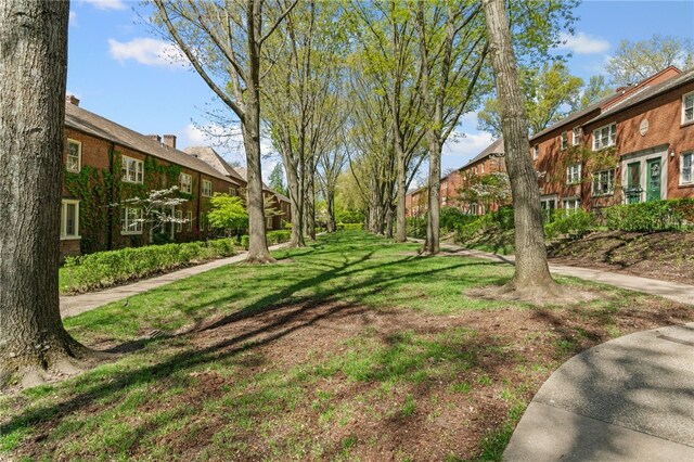 view of green lawn with a residential view