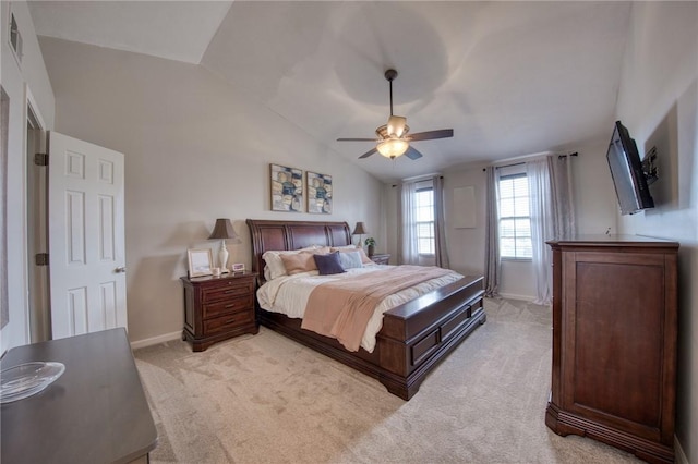 bedroom with baseboards, light colored carpet, vaulted ceiling, and a ceiling fan