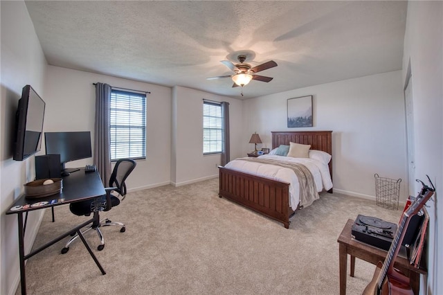 bedroom featuring carpet flooring, an office area, baseboards, and ceiling fan