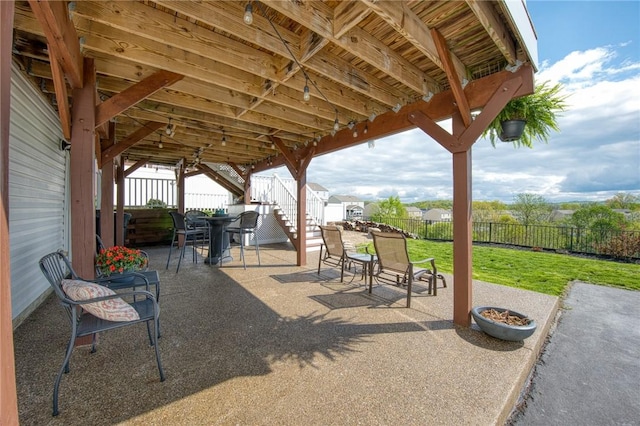view of patio / terrace featuring outdoor dining area and stairs