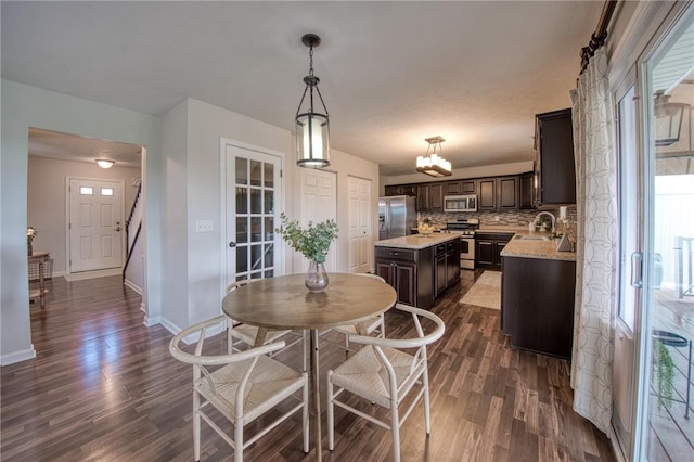 dining room with dark wood-style flooring and baseboards