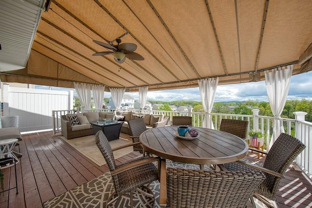 deck with ceiling fan and an outdoor living space
