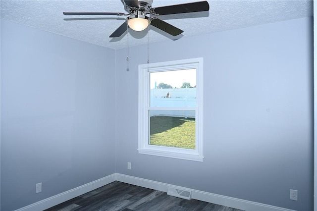 unfurnished room featuring dark wood finished floors, a textured ceiling, baseboards, and a ceiling fan