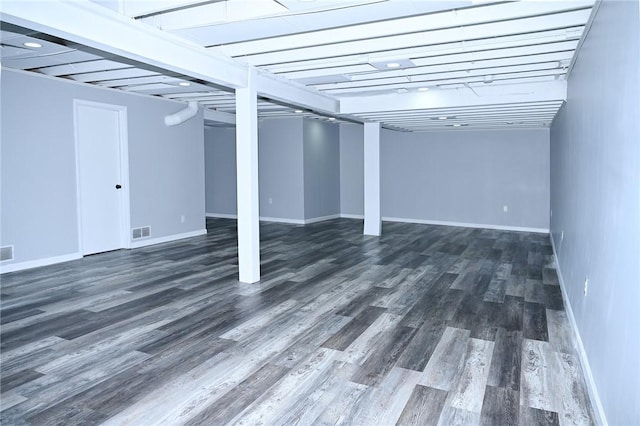 finished below grade area with wood finished floors and baseboards