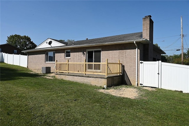 rear view of property featuring a chimney, brick siding, central AC unit, a deck, and a gate