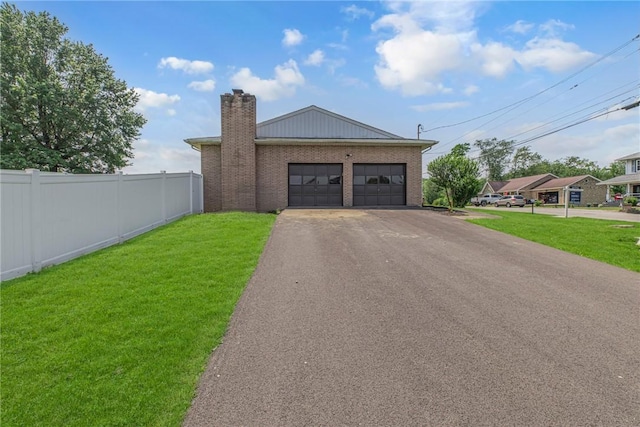 1301 Bechtel St, Monaca, PA 15061 - view of front of home with asphalt driveway, a chimney, a garage, and brick siding