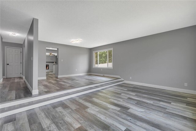 1301 Bechtel St, Monaca, PA 15061 - unfurnished room with wood finished floors, a textured ceiling, and a ceiling fan