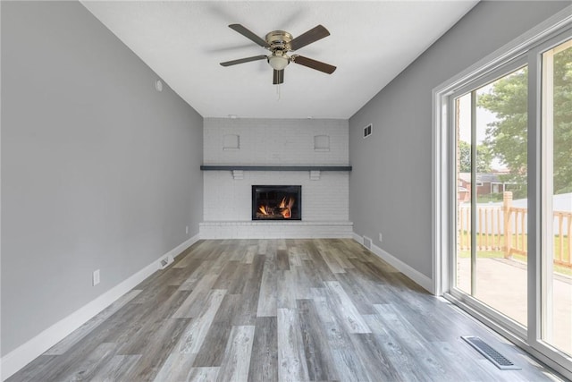 1301 Bechtel St, Monaca, PA 15061 - unfurnished living room with ceiling fan, wood finished floors, and a brick fireplace