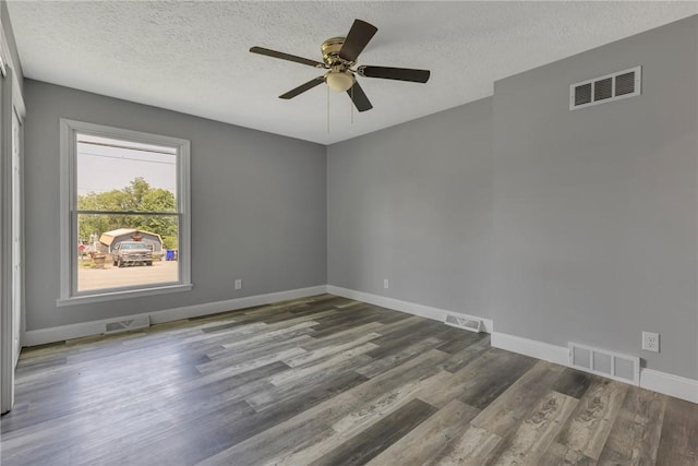 1301 Bechtel St, Monaca, PA 15061 - spare room featuring a textured ceiling, wood finished floors, and a ceiling fan