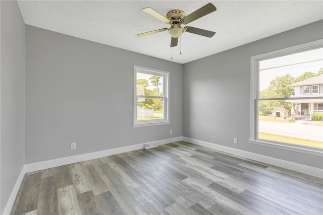 1301 Bechtel St, Monaca, PA 15061 - spare room featuring wood finished floors, a ceiling fan, and a textured ceiling