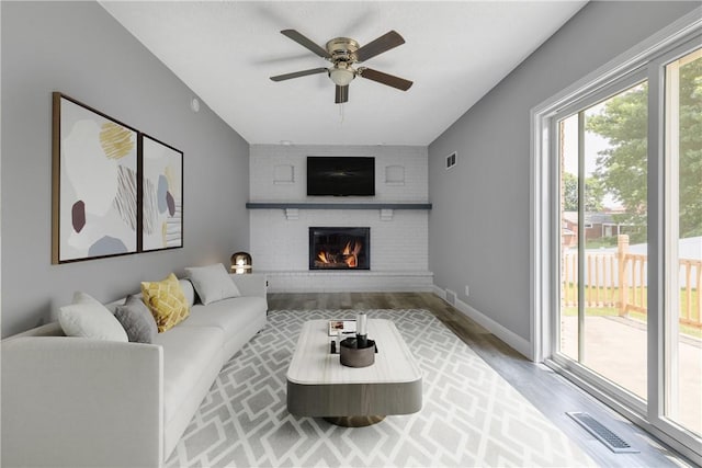 1301 Bechtel St, Monaca, PA 15061 - living room with a ceiling fan, wood finished floors, and a fireplace