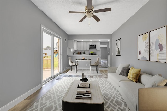 1301 Bechtel St, Monaca, PA 15061 - living area featuring light wood-style floors and a ceiling fan