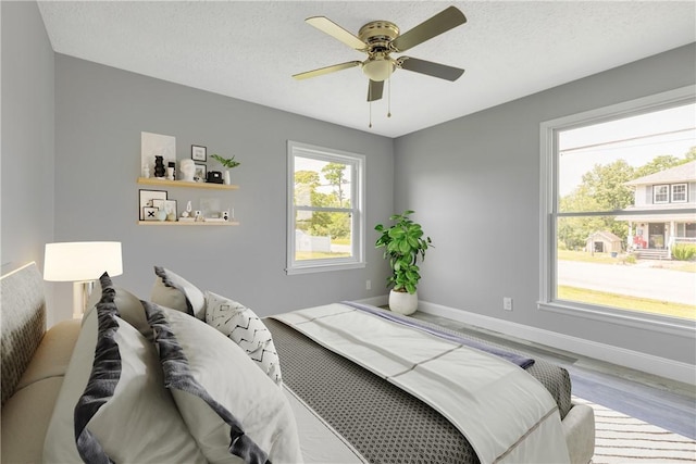1301 Bechtel St, Monaca, PA 15061 - bedroom with wood finished floors, ceiling fan, and a textured ceiling