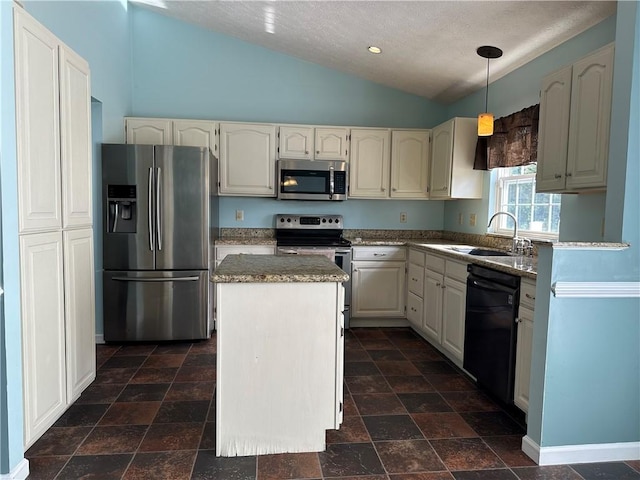 kitchen with stainless steel appliances, a sink, vaulted ceiling, a kitchen island, and hanging light fixtures