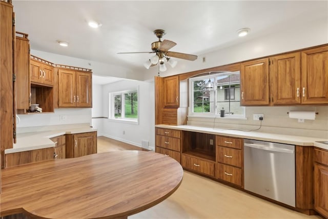 kitchen featuring dishwasher, ceiling fan, and brown cabinetry