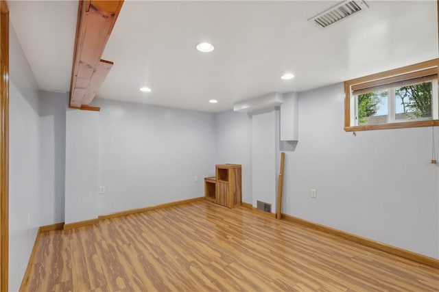 basement with wood finished floors, recessed lighting, and baseboards