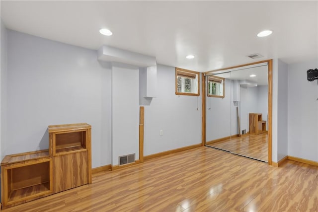below grade area featuring wood finished floors, baseboards, and recessed lighting