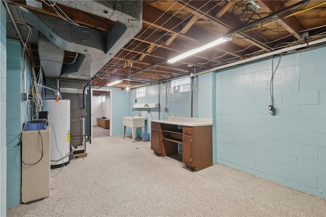 basement featuring water heater and a sink