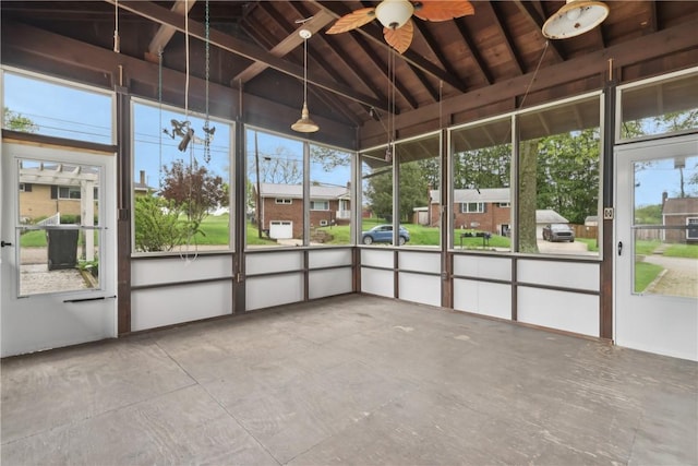 unfurnished sunroom featuring a ceiling fan